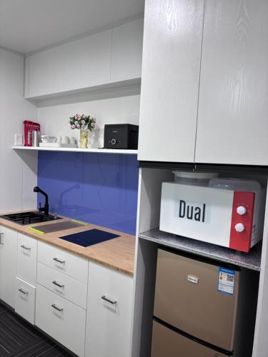 a white kitchen with a delivery box on the counter at Amber Lake B in Auckland