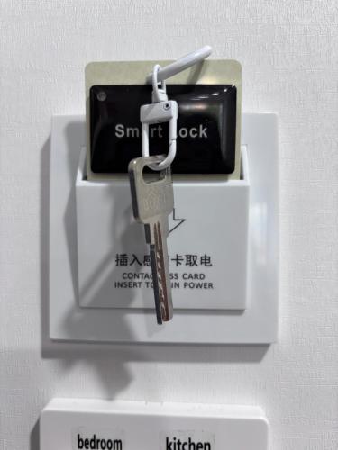 a pair of keys on a white box with a cell phone at Amber Lake B in Auckland