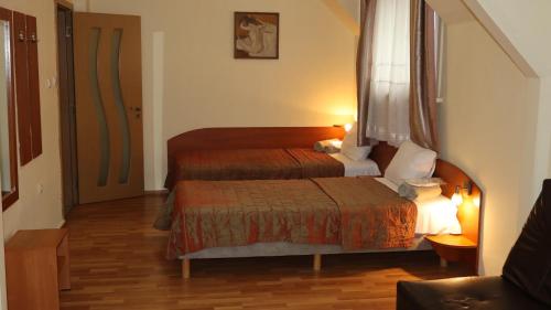 a hotel room with two beds and a window at Hotel Palitra in Varna City