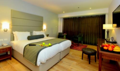 a hotel room with a bed and a table with fruit on it at Astoria Galilee Hotel in Tiberias