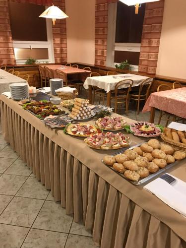 a long table with many plates of food on it at Penzion POD SMRKEM - budova A in Jeseník