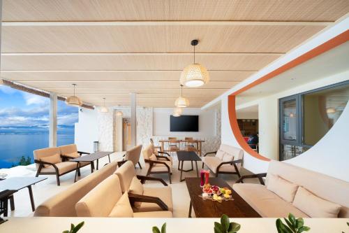 a living room with a couch and tables and chairs at 大理麓屿悬崖海景民宿 in Dali