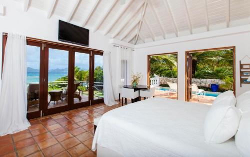 a bedroom with a bed and a view of the ocean at Luxury Villa in George Hill