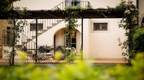 a house with a patio and a staircase at Dimora Ghirlandaio in Impruneta
