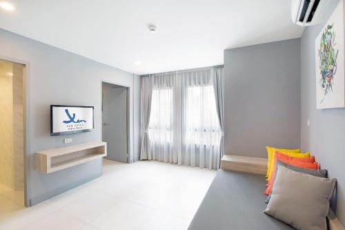 佛统Xen Hotel Nakhon Pathom - SHA PLUS的带沙发和窗户的客厅