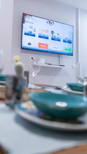 a bowl on a plate on a table with a television at O&O Group - The SeaGate Estate suites - Suite 1 in Rishon LeẔiyyon