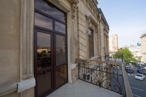 a balcony with glass doors on a building at Passage Hotel in Baku