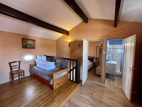 a bedroom with a bed and a chair in a room at Mais 2 pièces mezza CHATELAILLON PLAGE - CL080-022 in Châtelaillon-Plage