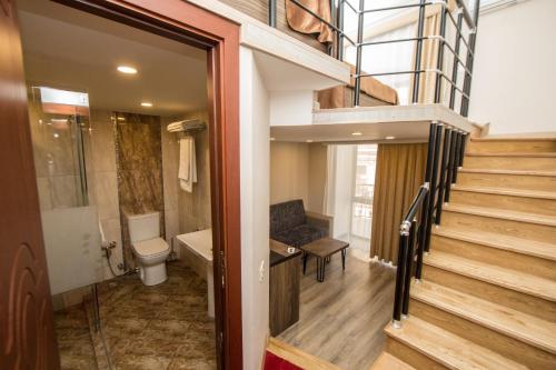 a bathroom with a toilet and a staircase in a house at Passage Hotel in Baku