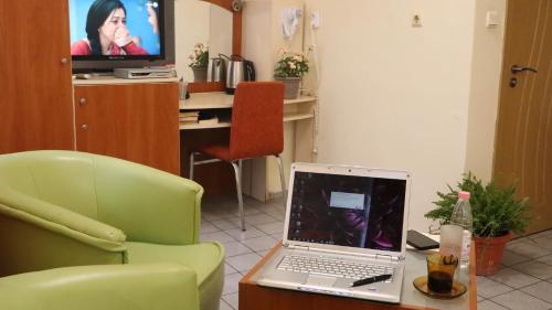 a laptop computer sitting on a table in a room at Hotel Palitra in Varna City