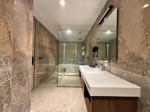 ein Badezimmer mit Waschbecken und Dusche in der Unterkunft The Eastern Grace Hotel in Buxar