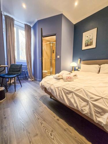 a bedroom with a large bed and a table and chairs at Hôtel Les Voyageurs in Bastia