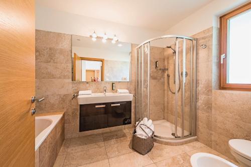 a bathroom with a sink and a shower and a toilet at Unterpenatz Schenna in Schenna