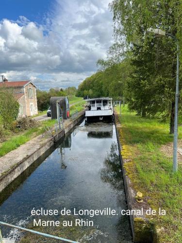 a boat is docked in a canal at Riverside in Longeville-en-Barrois