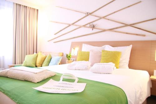 a hotel room with a large bed with a sign on it at Novotel Warszawa Airport in Warsaw
