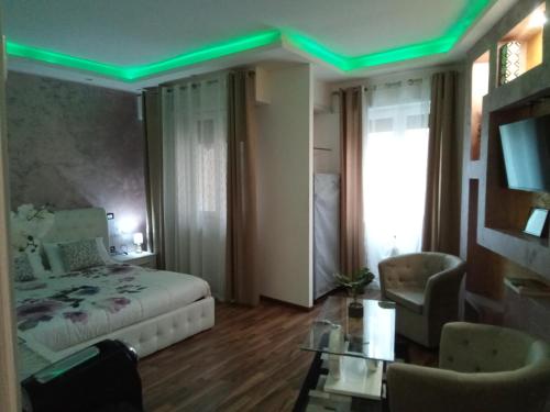 a bedroom with a bed and a green lighting at Katrin luxury in Verona