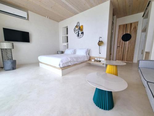 a bedroom with a bed and a table and a couch at Escape by Orchid in Batroûn