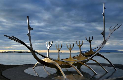a metal sculpture of a boat on the water at Black diamond villa in Mosfellsbær
