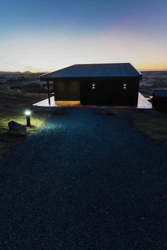 a house with a dark roof with a light on it at Black diamond villa in Mosfellsbær