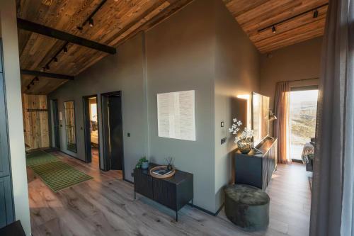 a living room with wooden ceilings and wood floors at Black diamond villa in Mosfellsbær
