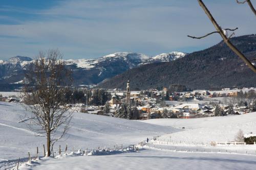 a snowy hill with a town in the distance at Il Fauno in Asiago