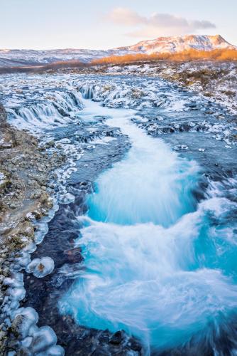 a frozen waterfall in the mountains with snow at Black diamond villa in Mosfellsbær