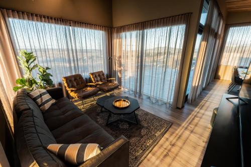 a living room with a couch and a table at Black diamond villa in Mosfellsbær