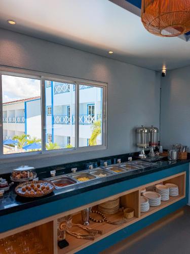 a buffet line in a restaurant with some food at Hotel Paraiso Maragogi LTDA in Maragogi