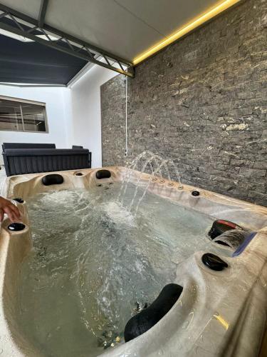 a jacuzzi tub with water being poured into it at RÉSIDENCE LE BIjOU DE L'AGDAL in Rabat