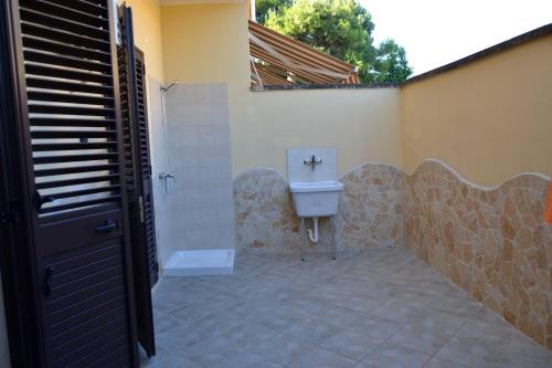 a bathroom with a toilet and a sink at San Cataldo Holiday's in San Cataldo