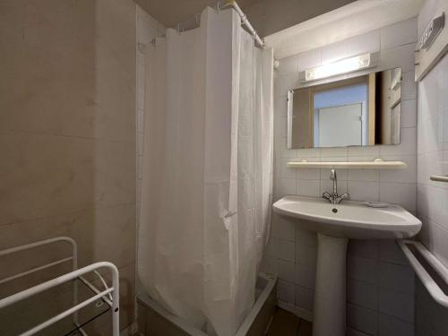 une salle de bain blanche avec un lavabo et un miroir dans l'établissement Maison Studio Mezzanine - Gruissan GN530-013, à Gruissan