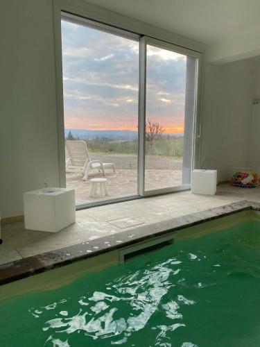 a swimming pool in a house with a view of the ocean at Casale del Vacanziere in Certaldo