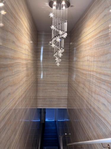 a staircase with a chandelier in a building at Amber Lake D in Auckland