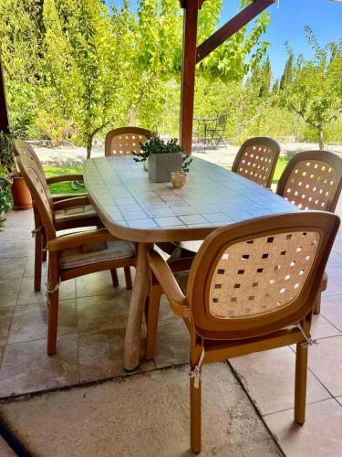 a wooden table and chairs on a patio at Demelida Villa in Tsada, Paphos in Tsadha