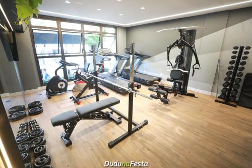a gym with two treadmills and cardio machines at Apto em Home Clube na Praia de Palmas in Governador Celso Ramos