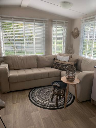 a living room with a couch and a table at Chalet Oase VB01 Renesse in Renesse