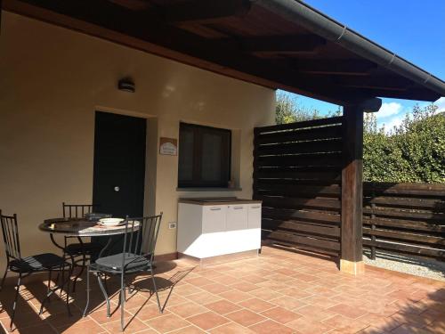 a patio with a table and chairs and a kitchen at Casaguidoni Roberto in Follonica