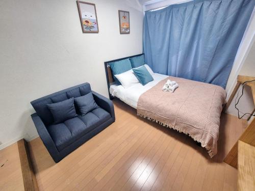 Postel nebo postele na pokoji v ubytování Nogata House