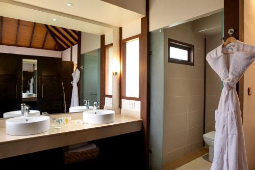 a bathroom with two sinks and a mirror at Lakowe Lakes Hotel, Golf and Country Estate by NEWMARK in Lagos