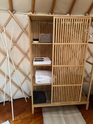 a wooden book shelf in a yurt at Yurt in Be Bernartice in Bernartice