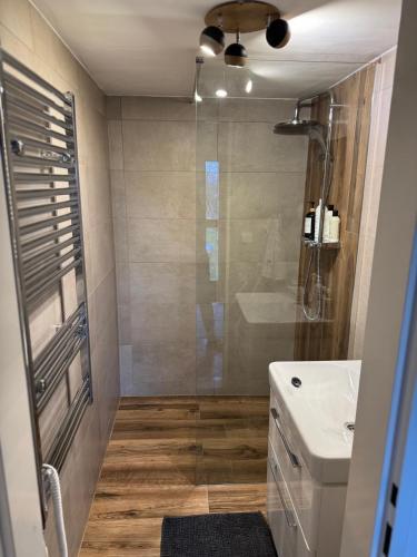 a bathroom with a shower and a toilet and a sink at Yurt in Be Bernartice in Bernartice