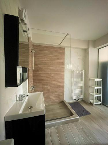 a bathroom with a sink and a shower with a tub at Panorama Sunvilles Apartment 3 in Thessaloniki