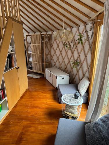 a living room with a couch and a table at Yurt in Be Bernartice in Bernartice
