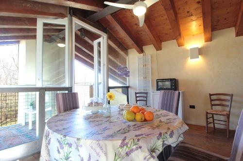 a dining room table with a bowl of fruit on it at Silea Apartments, Pool, Garden, Treviso in Silea