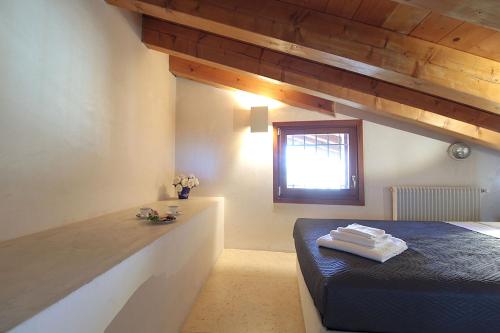 a bedroom with a blue bed and a window at Silea Apartments, Pool, Garden, Treviso in Silea