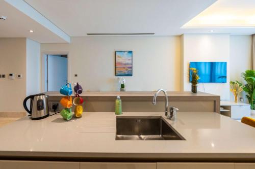 a kitchen with a sink and a counter top at Spacious beachfront 2 bedroom apartment - The 8 in Dubai