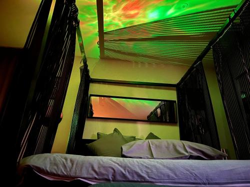 a room with a bed in a room with a ladder at Love Spa Normandie in Saint-Pois