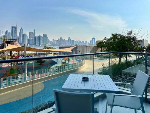 a balcony with a table and chairs and a view of a city at Renovated Marina view apartment in Oceana in Dubai