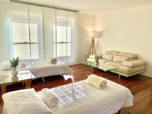 a living room with two beds and a couch at 7kW EV Point,King Bed,1 Story Spacious All Ages Entertainer in Dunmore