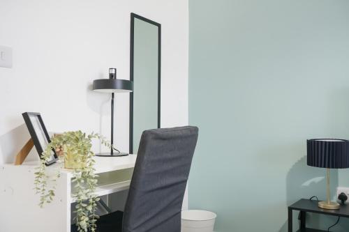 a desk with a chair and a mirror at Affordable 1 & 2 Bed Apartments in Slough, Great Heathrow Location in Colnbrook